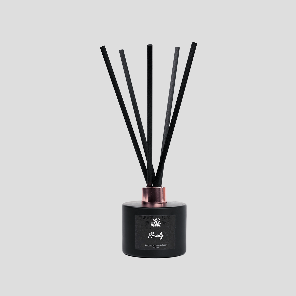 Moody reed diffuser with black reeds on a plain background