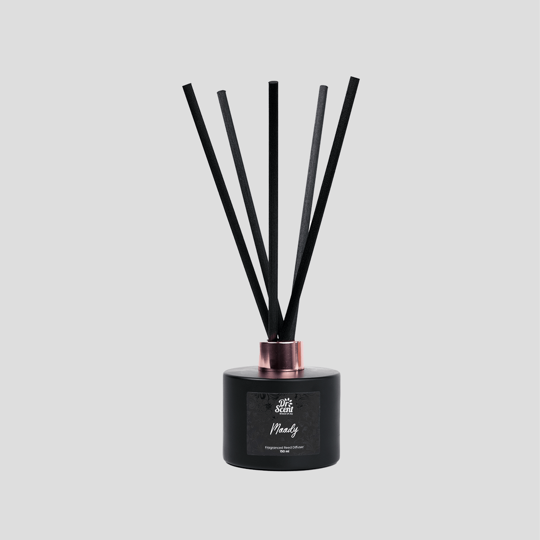 Moody reed diffuser with black reeds on a plain background