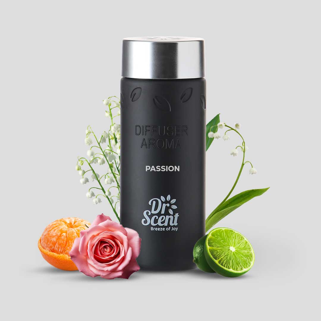 Passion fruity floral fragrance oil bottle beside orange, lime and a pink rose